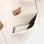 Poche extérieure avec motif ourson du sac à langer écru