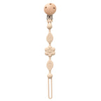 Attache-tétine fleur beige en silicone et clip en bois